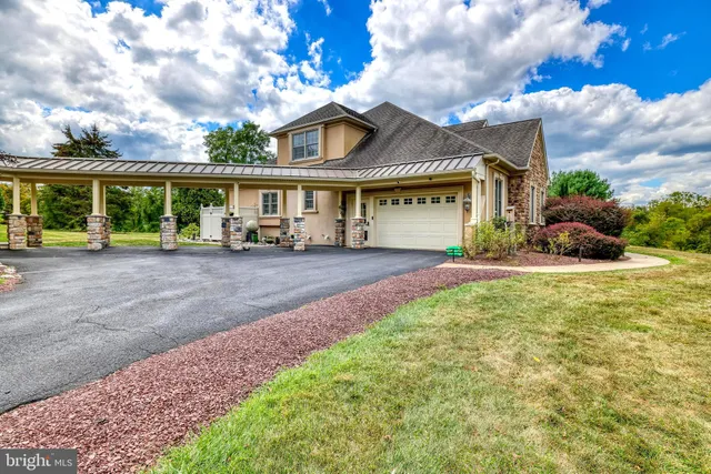 a view of house with outdoor space and sitting area