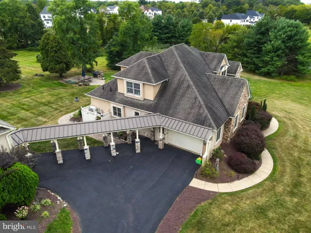 an aerial view of a house with yard swimming pool and outdoor seating