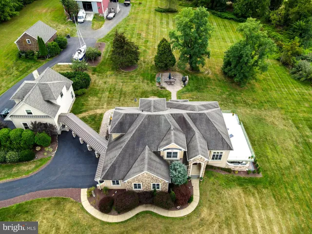 an aerial view of a house with garden space and street view