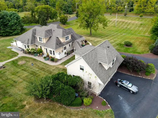 an aerial view of a house with outdoor space and a lake view