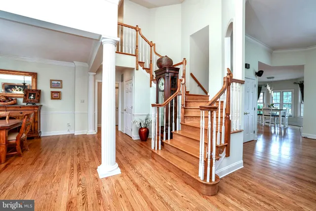 a kitchen with stainless steel appliances granite countertop a stove a refrigerator a kitchen island with a dining table and chairs