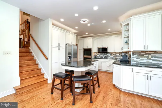 a view of a kitchen with dining table and windows