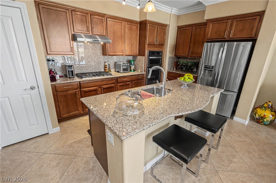 2555 Hampton Road, Unit 3308 Henderson, NV 89052 - Photo 23 of 65 A well-appointed kitchen features rich wood cabinetry, granite countertops, and modern stainless steel appliances.