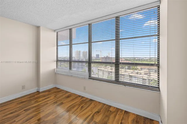 a view of an empty room and wooden floor