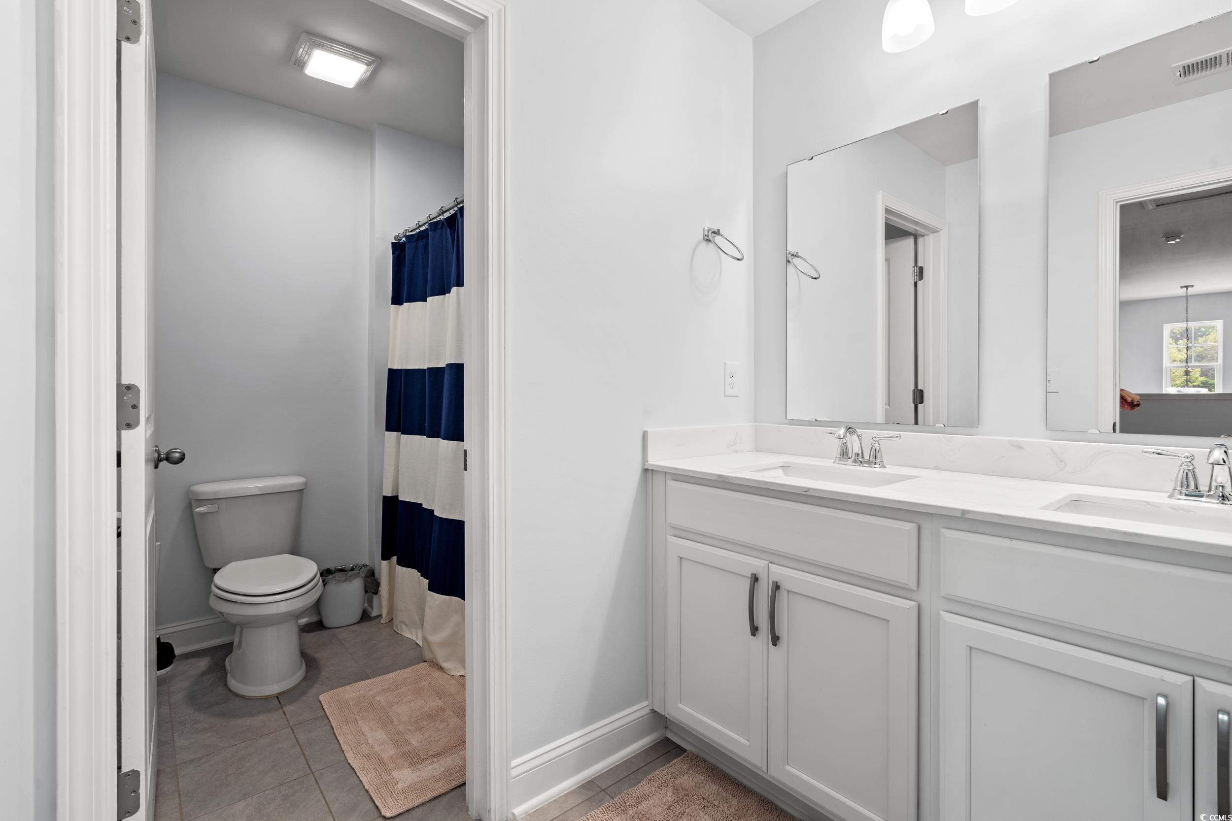 405 Spring View Little River, SC 29566 - Photo 32 of 40 Bathroom featuring double vanity, tile patterned flooring, and a shower with curtain