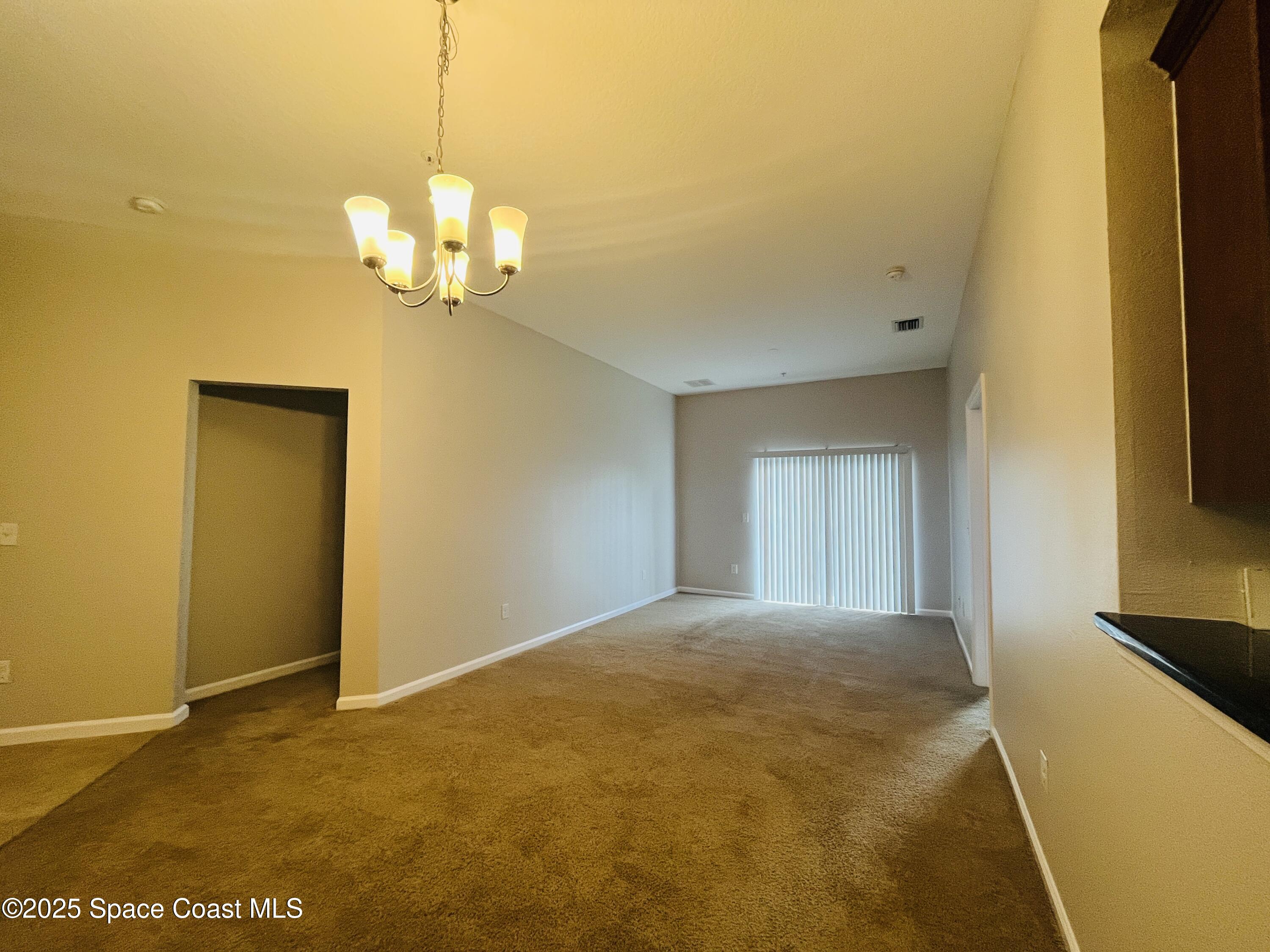 4017 Meander Place, Unit 103 Rockledge, FL 32955 - Photo 4 of 10 a view of a livingroom with a chandelier