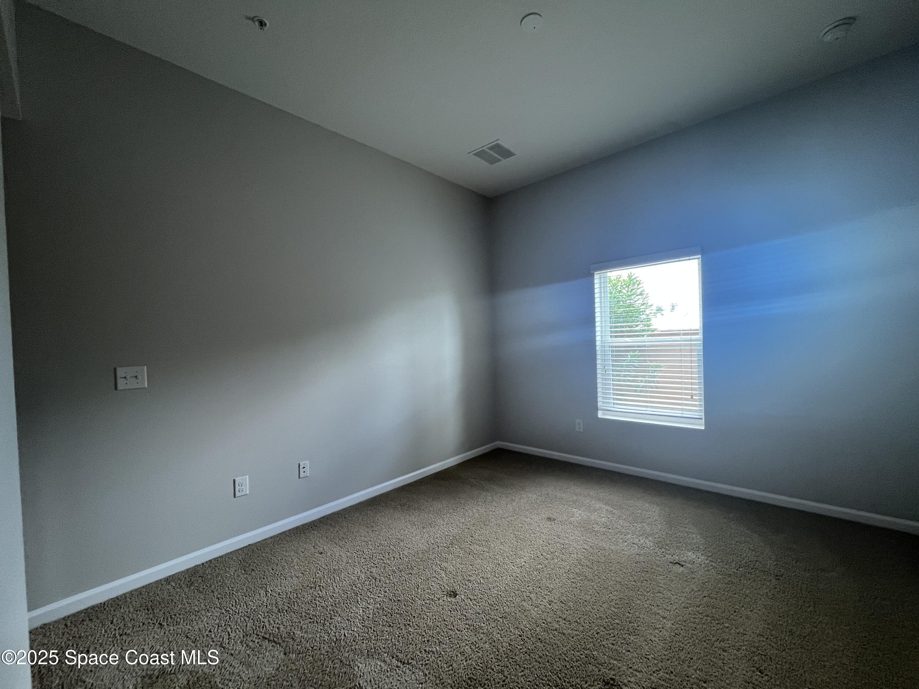4017 Meander Place, Unit 103 Rockledge, FL 32955 - Photo 5 of 10 an empty room with a window