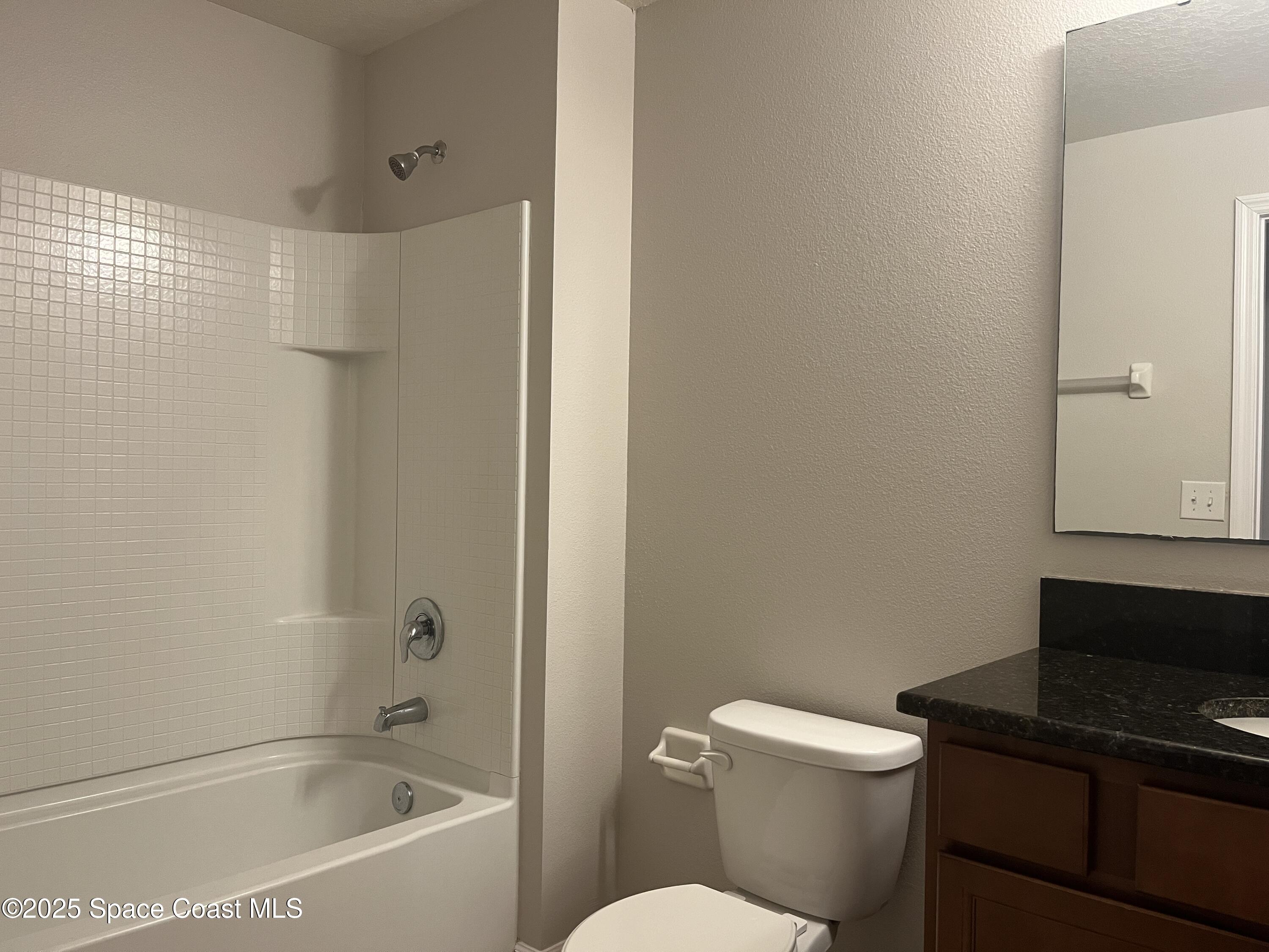 4017 Meander Place, Unit 103 Rockledge, FL 32955 - Photo 7 of 10 a bathroom with a bathtub and a toilet