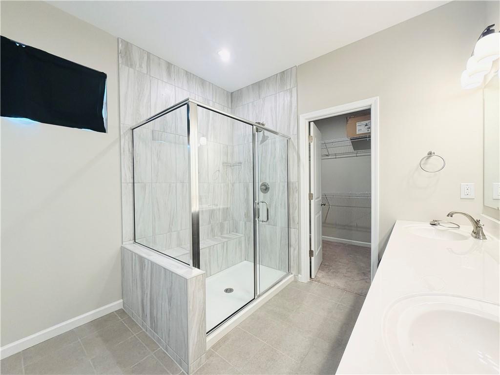 607 Michigan Circle Hoschton, GA 30548 - Photo 14 of 27 a bathroom with a tub and a shower