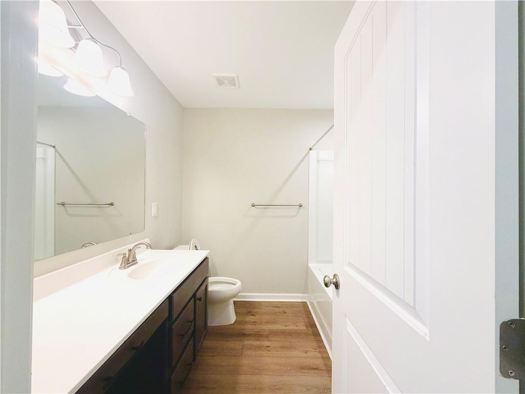 607 Michigan Circle Hoschton, GA 30548 - Photo 20 of 27 a bathroom with a sink a toilet and shower