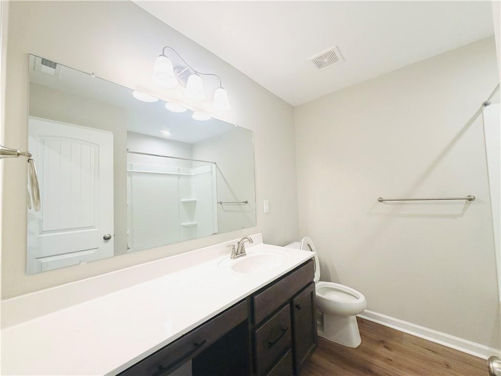 607 Michigan Circle Hoschton, GA 30548 - Photo 21 of 27 a bathroom with a sink a toilet and shower