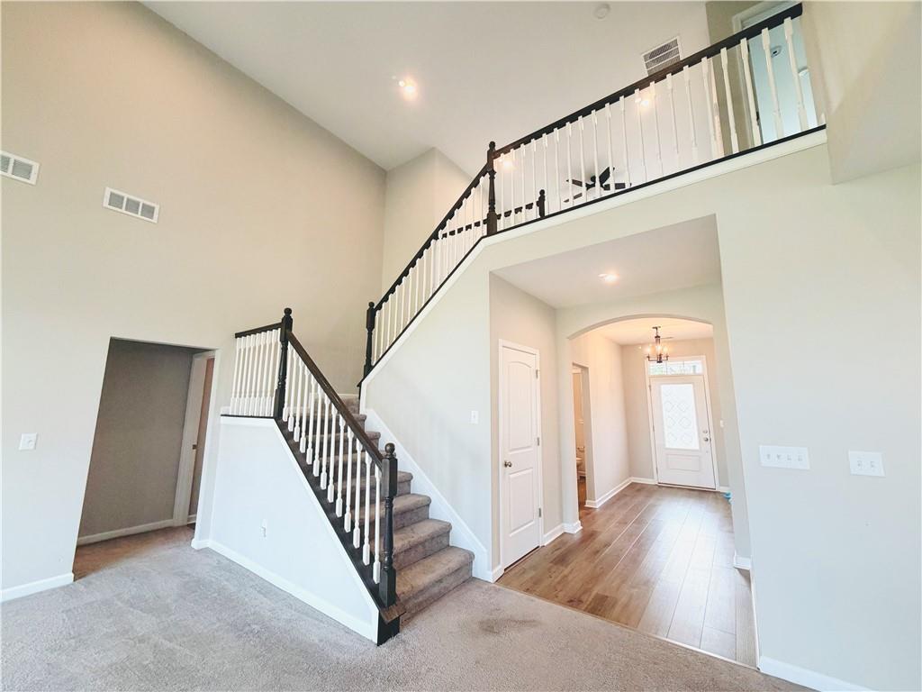 607 Michigan Circle Hoschton, GA 30548 - Photo 4 of 27 a view of staircase with railing and white walls
