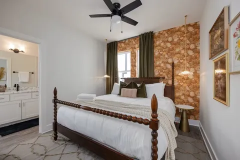 a bedroom with a bed and a chandelier
