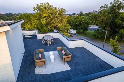 a bathroom with a granite countertop sink a mirror a vanity and shower