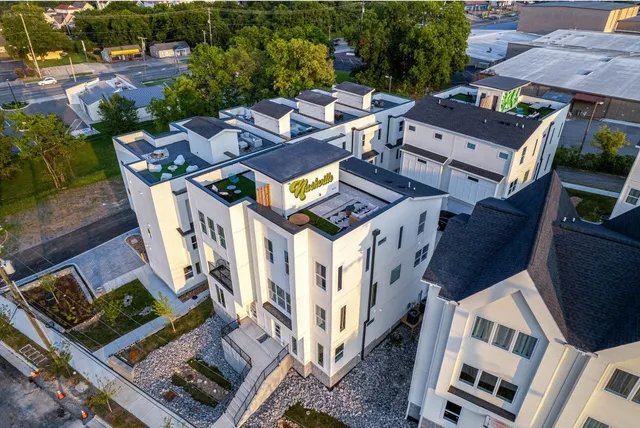 an aerial view of a house with a yard