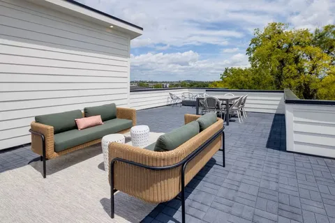 a balcony with furniture and a potted plant