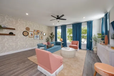 a living room with furniture and a large window