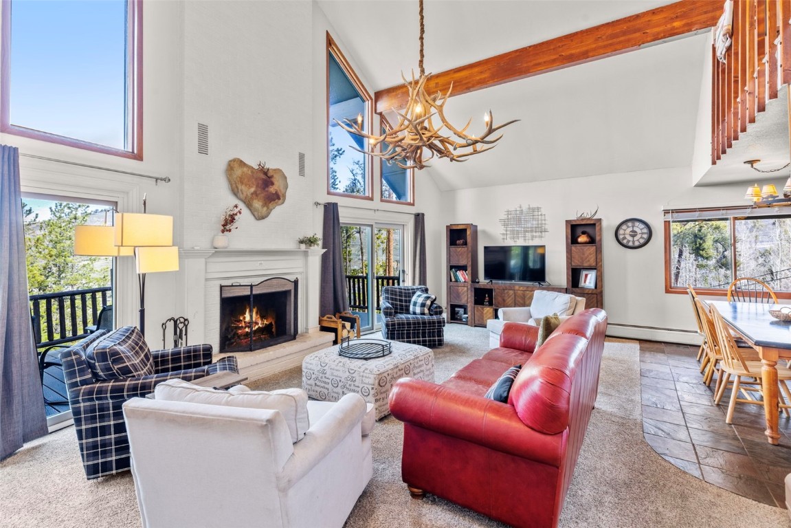 79 Forest Canyon Road Dillon, CO 80435 - Photo 8 of 50 Living room with baseboard heating, high vaulted ceiling, beamed ceiling, and a notable chandelier