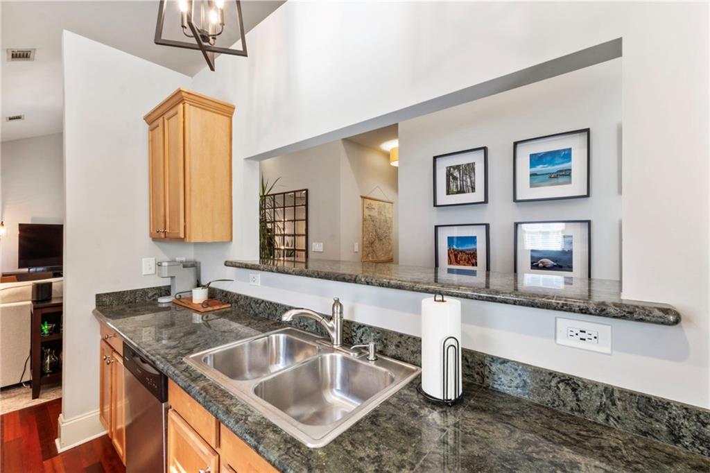 173 Berean Avenue Southeast Atlanta, GA 30316 - Photo 24 of 61 a bathroom with a granite countertop sink a mirror and shower