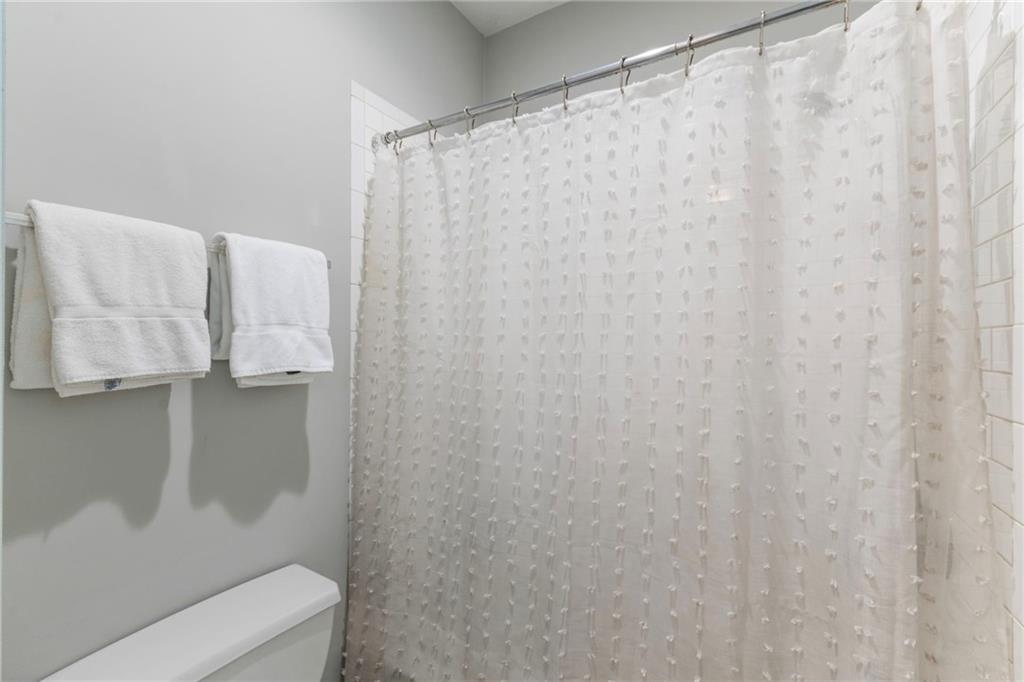 173 Berean Avenue Southeast Atlanta, GA 30316 - Photo 47 of 61 a bathroom with a shower curtain and sink