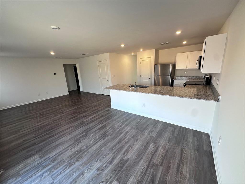 536 Pemberton Street Euharlee, GA 30145 - Photo 3 of 9 a large kitchen with a sink and wooden floor