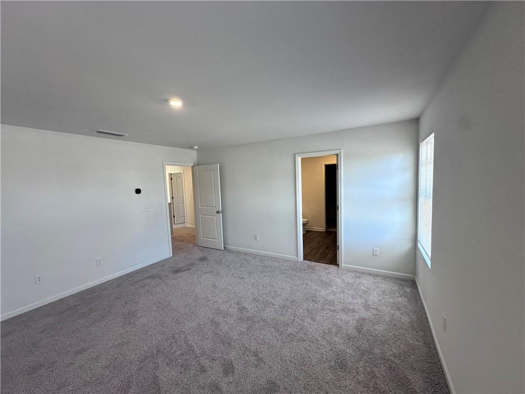 536 Pemberton Street Euharlee, GA 30145 - Photo 5 of 9 a view of an empty room with closet and wooden floor