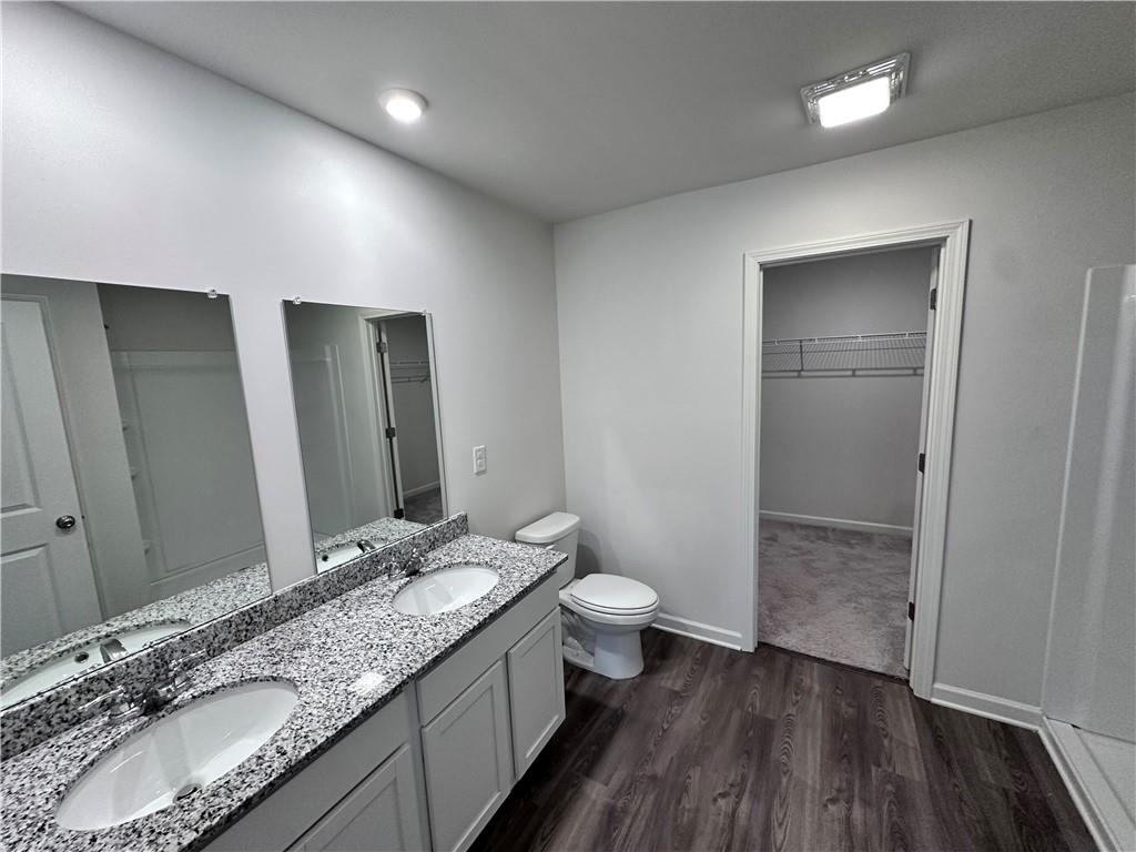 536 Pemberton Street Euharlee, GA 30145 - Photo 6 of 9 a bathroom with a granite countertop sink toilet and shower