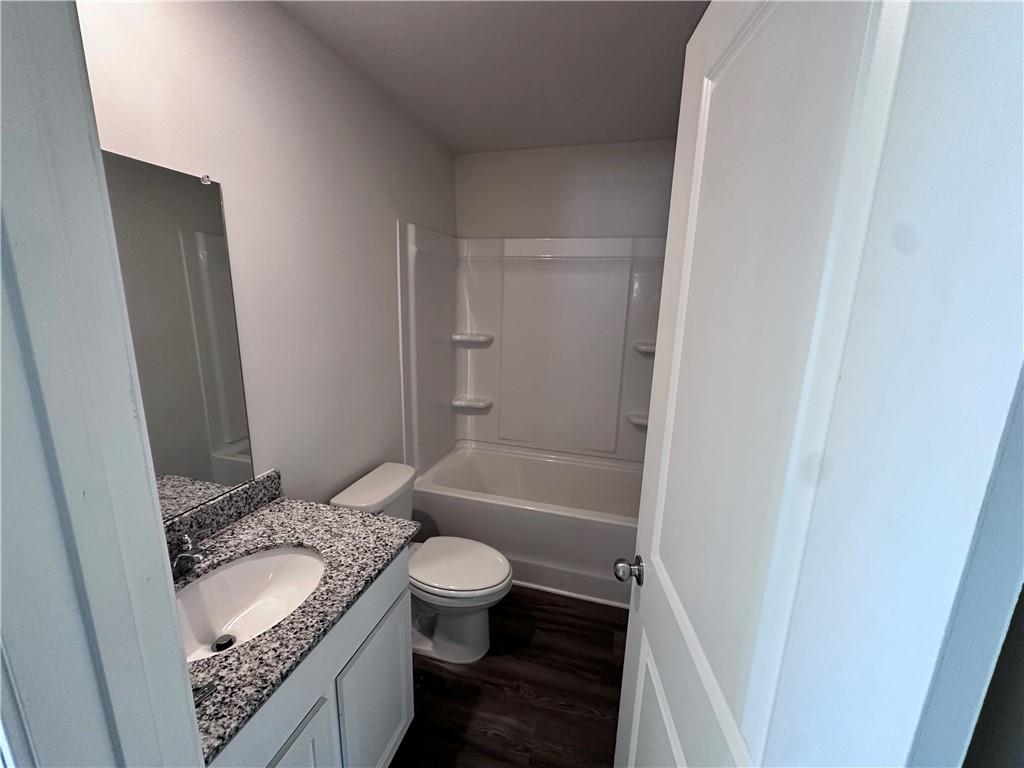 536 Pemberton Street Euharlee, GA 30145 - Photo 9 of 9 a bathroom with a granite countertop sink toilet and shower