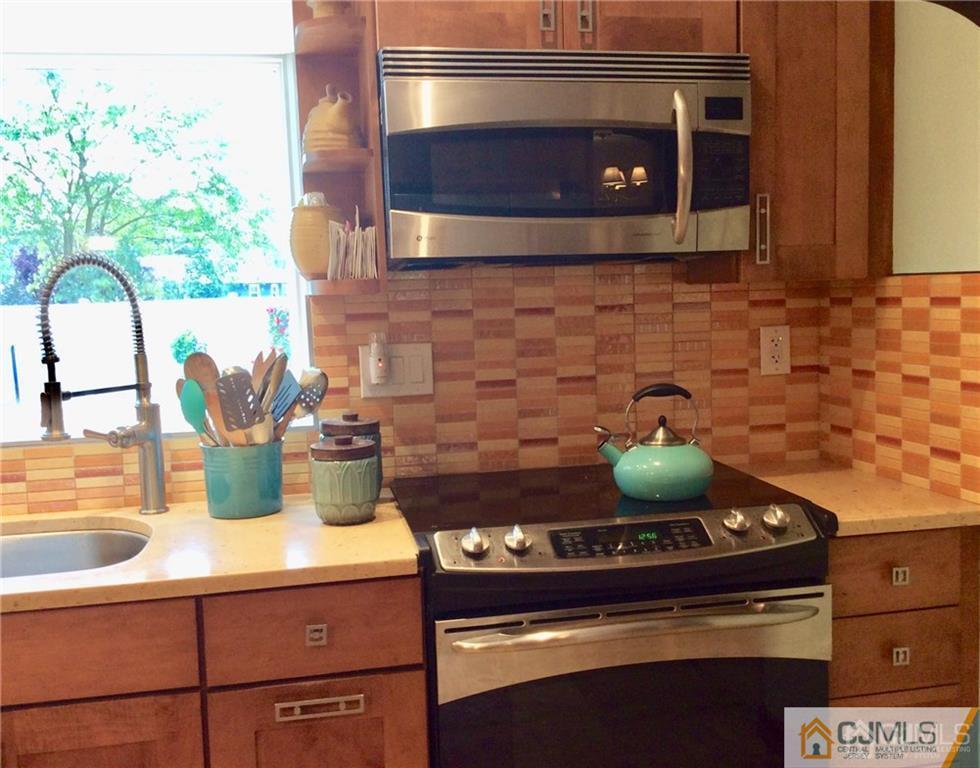 24 Rath Lane East Brunswick, NJ 08816 - Photo 12 of 25 a stove top oven sitting inside of a kitchen