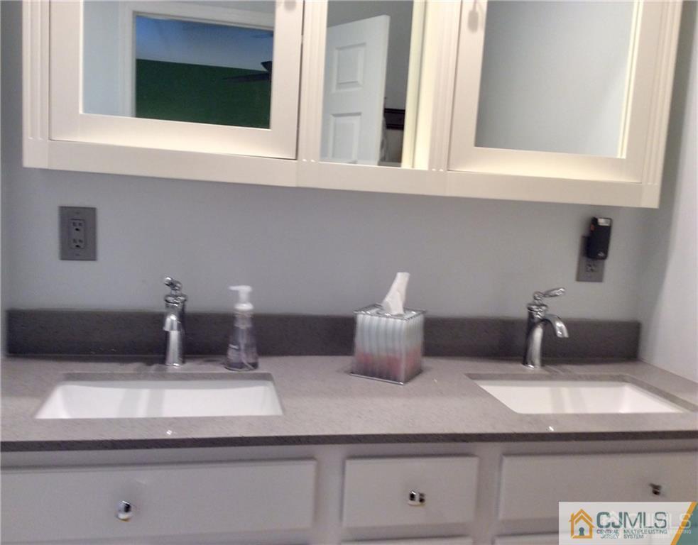 24 Rath Lane East Brunswick, NJ 08816 - Photo 19 of 25 a kitchen with a stove and white cabinets