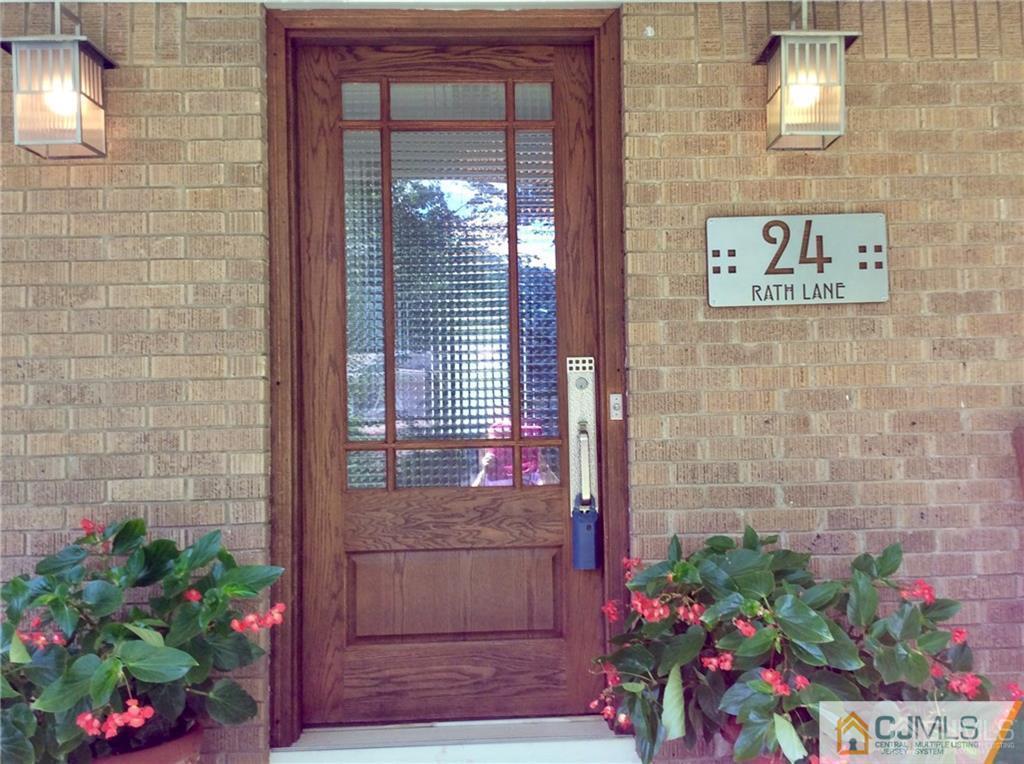 24 Rath Lane East Brunswick, NJ 08816 - Photo 2 of 25 a view of a wooden door and a potted plant
