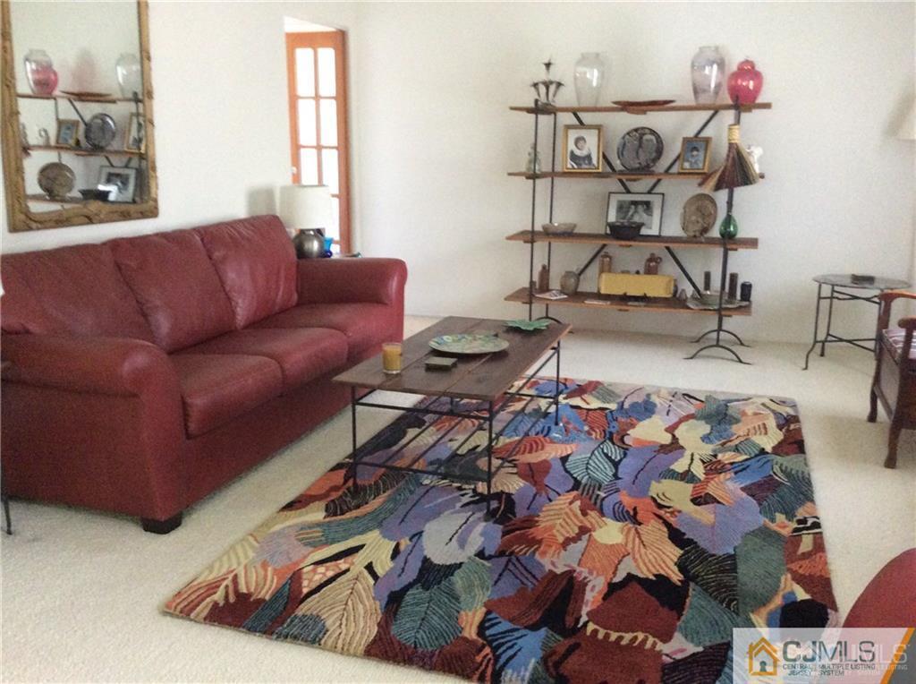 24 Rath Lane East Brunswick, NJ 08816 - Photo 4 of 25 a living room with furniture and a wooden floor
