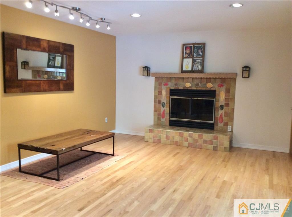 24 Rath Lane East Brunswick, NJ 08816 - Photo 6 of 25 a living room with furniture and a fireplace