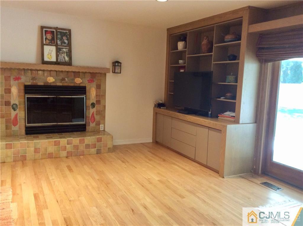 24 Rath Lane East Brunswick, NJ 08816 - Photo 7 of 25 a view of an empty room with a fireplace