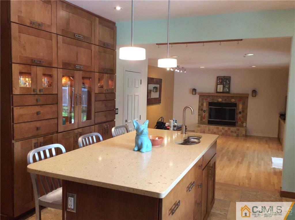 24 Rath Lane East Brunswick, NJ 08816 - Photo 9 of 25 a kitchen with a table chairs and a stove