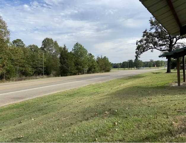 a view of a field with an trees