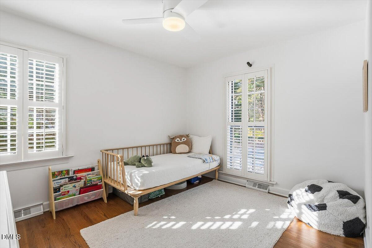 5904 Volant Drive Raleigh, NC 27609 - Photo 30 of 42 a bedroom with a bed and wooden floor