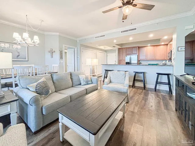 a living room with furniture a wooden floor and chandelier