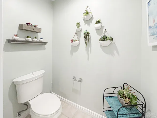 a white toilet sitting next to a bathroom sink and tub