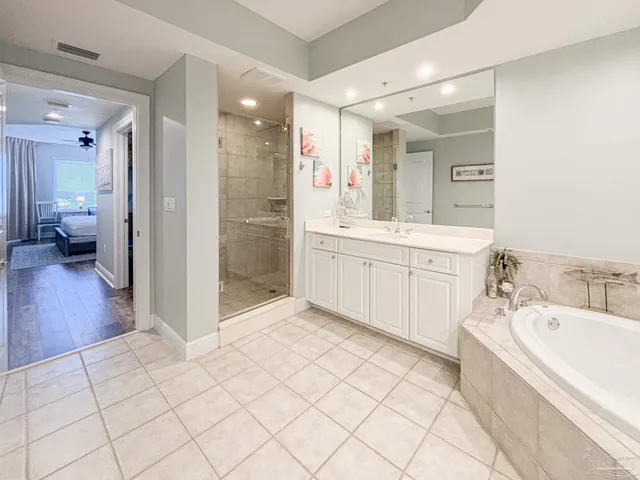 a bathroom with a tub sink and mirror