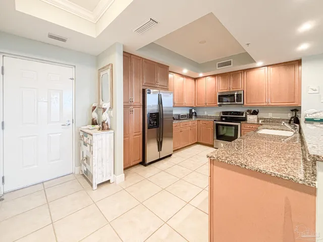 a kitchen with stainless steel appliances granite countertop a refrigerator stove and sink