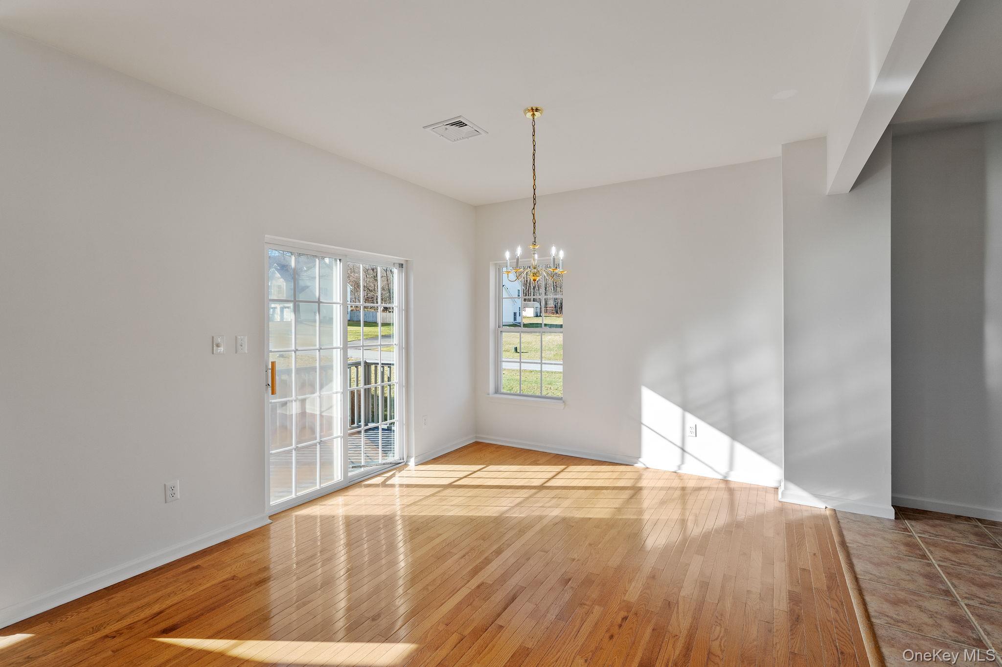 17 Carmella Road Highland, NY 12528 - Photo 11 of 48 Unfurnished dining area featuring light wood-style flooring and a chandelier