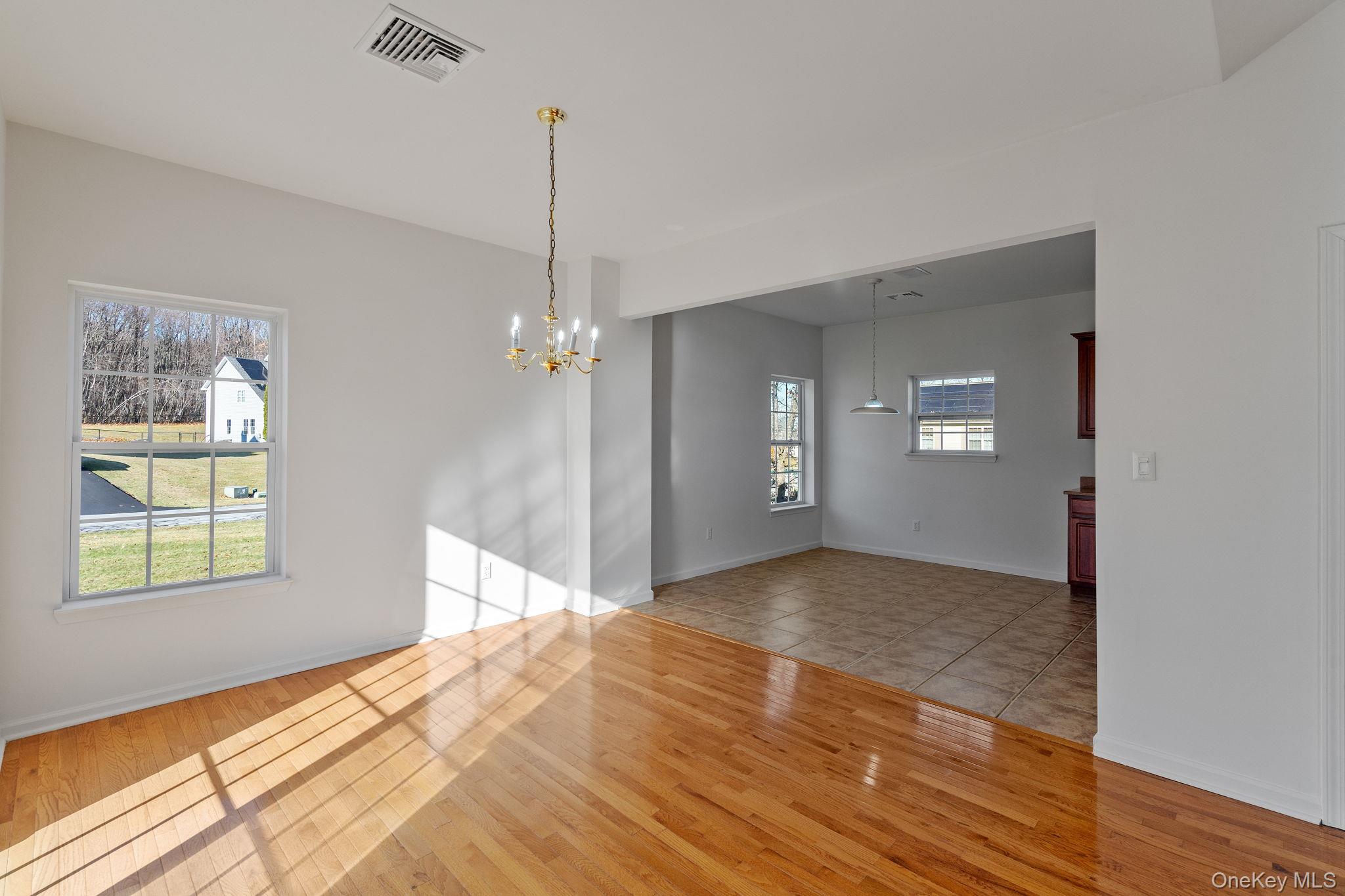 17 Carmella Road Highland, NY 12528 - Photo 12 of 48 Empty room featuring light wood-style flooring and a chandelier