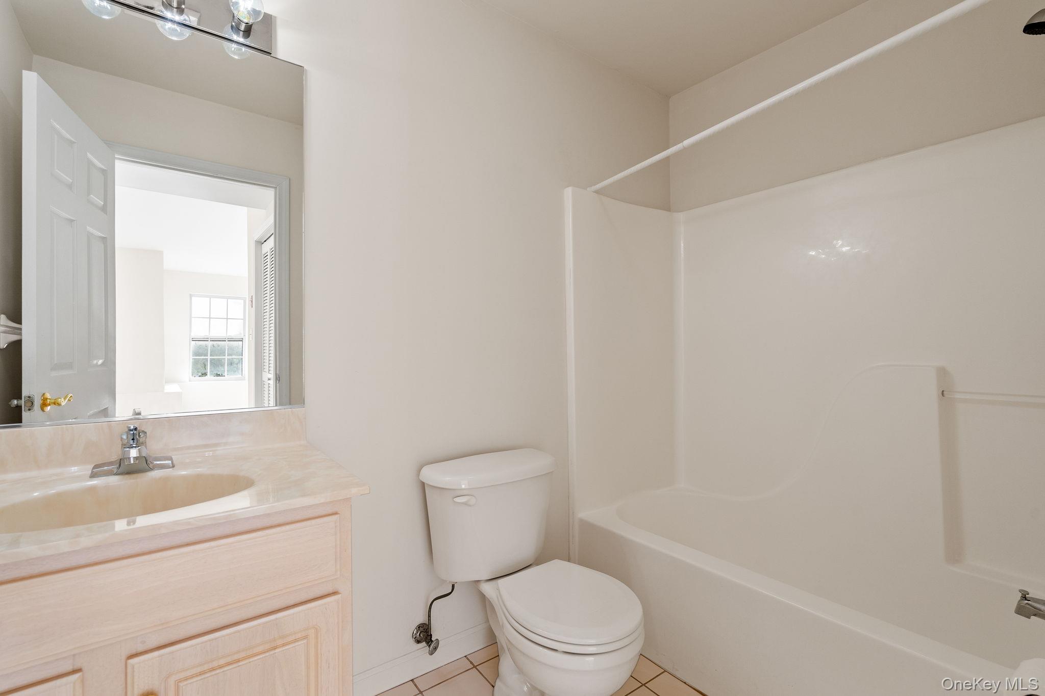 17 Carmella Road Highland, NY 12528 - Photo 40 of 48 Bathroom featuring vanity, shower / washtub combination, and light tile patterned floors