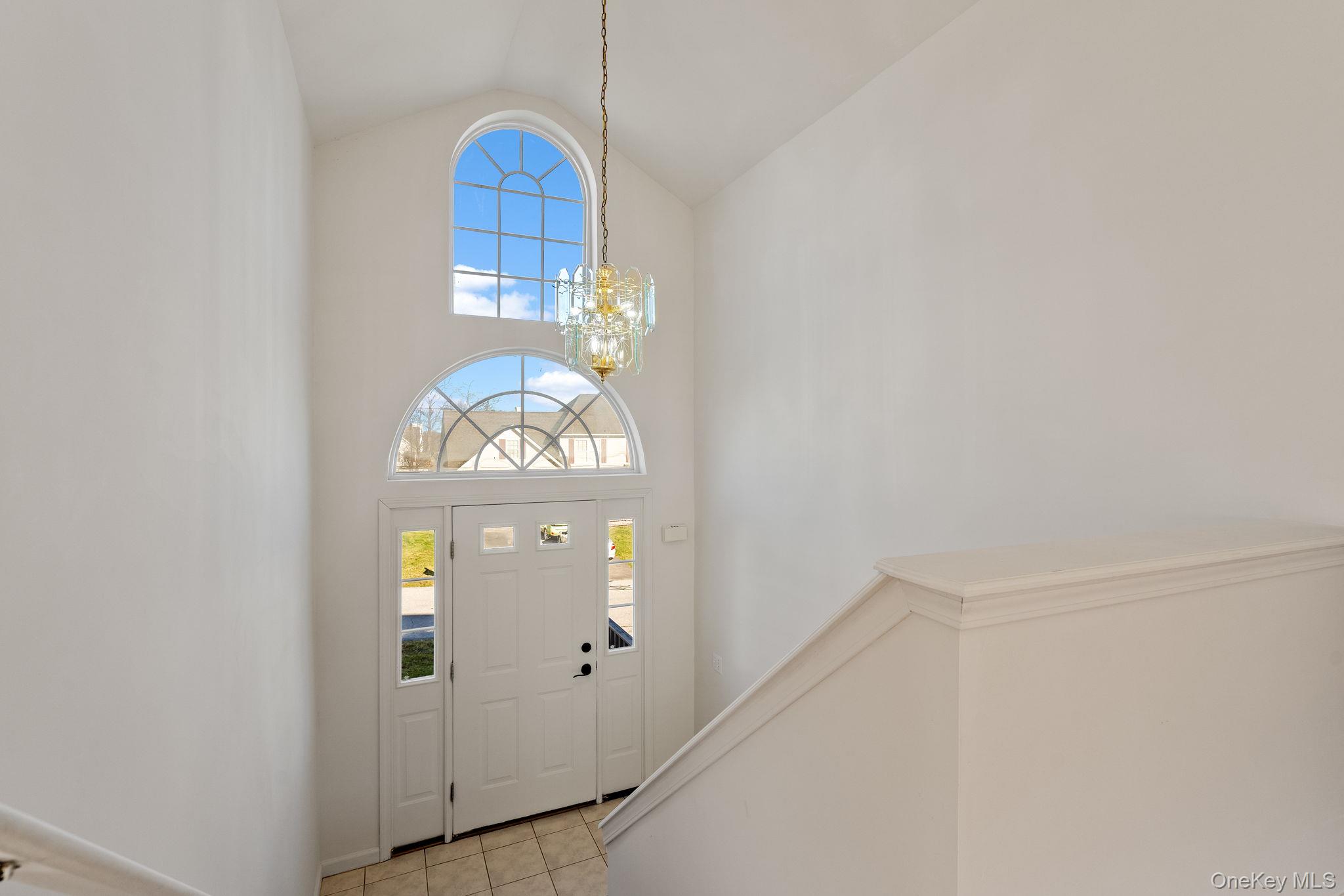 17 Carmella Road Highland, NY 12528 - Photo 5 of 48 Entrance foyer with plenty of natural light, a chandelier, light tile patterned floors, and high vaulted ceiling