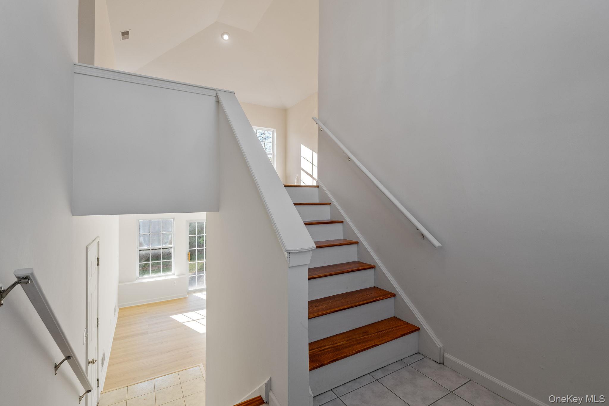 17 Carmella Road Highland, NY 12528 - Photo 6 of 48 Staircase with a high ceiling and tile patterned flooring