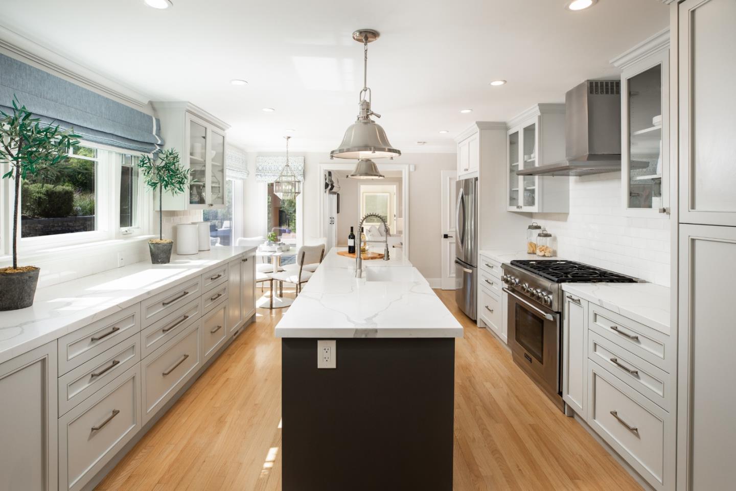 345 Harcross Road Woodside, CA 94062 - Photo 10 of 37 a large kitchen with granite countertop a stove a sink dishwasher and a wooden floor