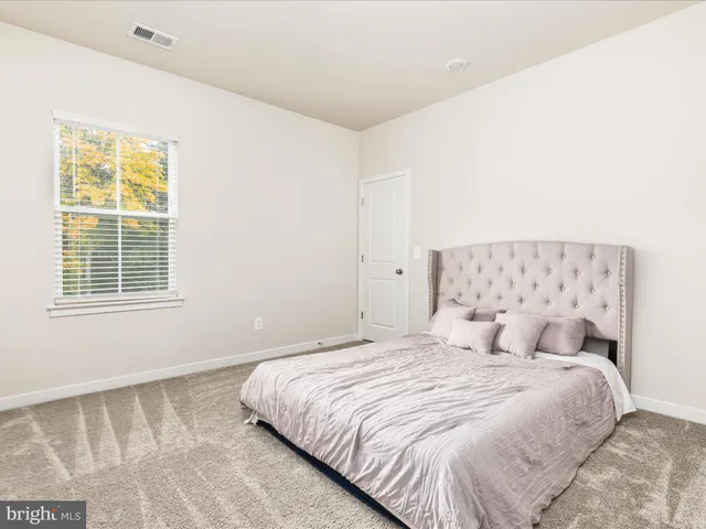 a bedroom with a bed and a night stand