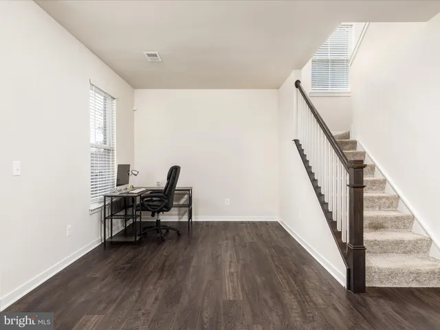 a kitchen with granite countertop a refrigerator and a stove