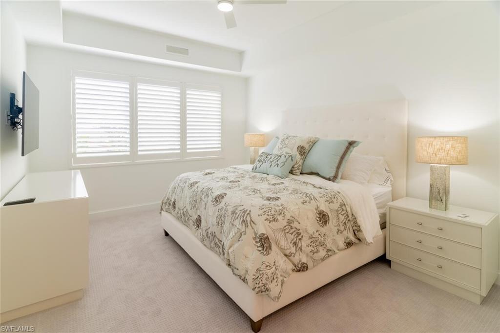 1125 Central Avenue, Unit 373 Naples, FL 34102 - Photo 20 of 49 a bed sitting in a bedroom next to a window